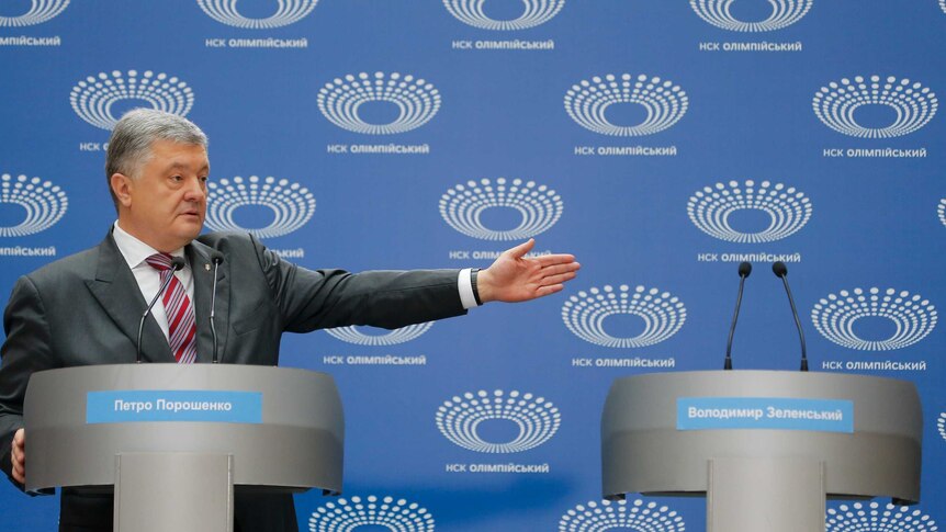 Ukrainian President Petro Poroshenko gestures as he answers to a journalist's question.