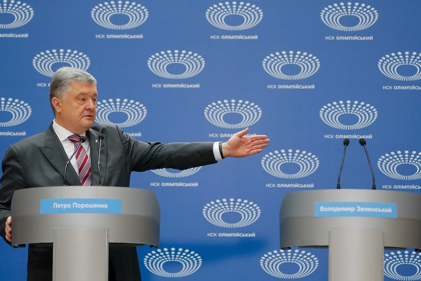 Ukrainian President Petro Poroshenko gestures as he answers to a journalist's question.