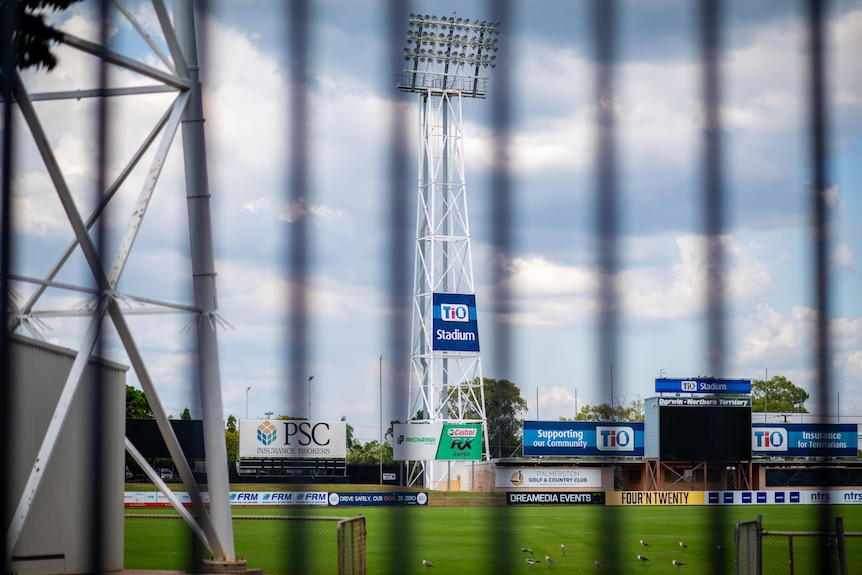 TIO Stadium playing field seen through gates during the day.