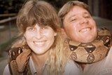 Terri and Steve Irwin with a snake wrapped around them
