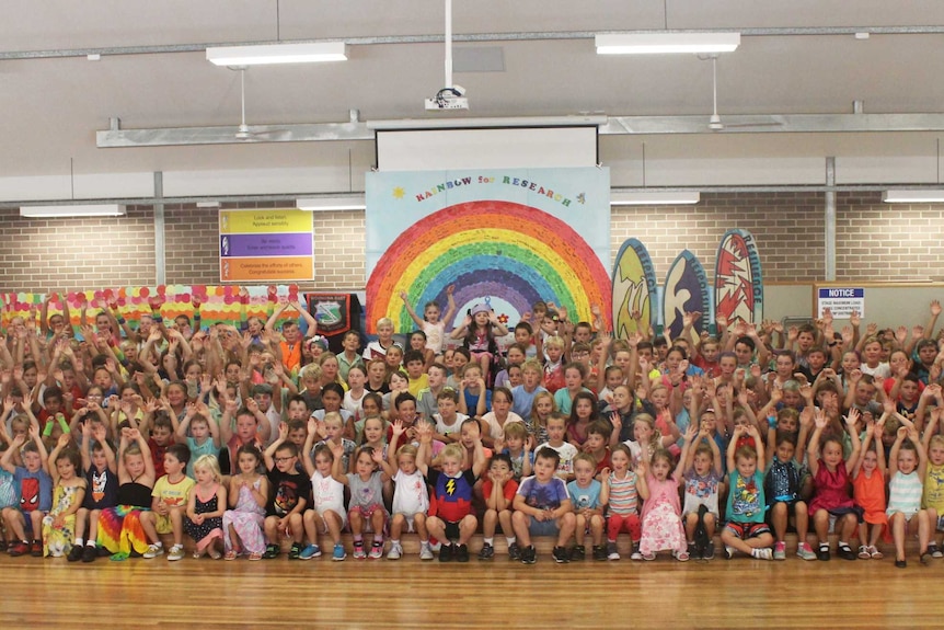 Students from Woonona East Public School gather in the school hall to raise funds for Chloe Saxby.