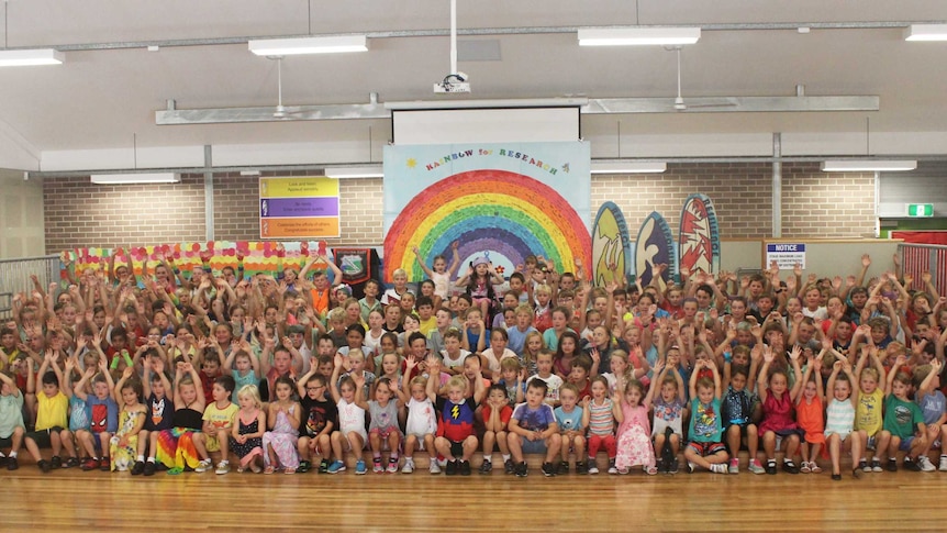 Students from Woonona East Public School gather in the school hall to raise funds for Chloe Saxby.