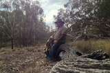 Gary Murray sits on a log