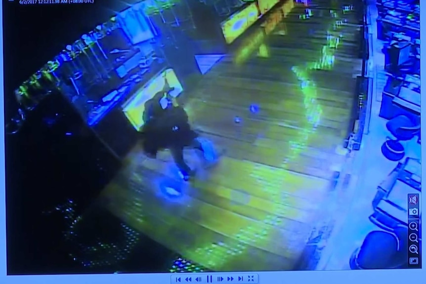 CCTV footage of the attacker holding an assault riffle.