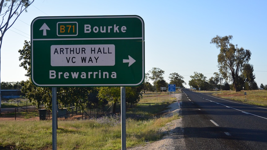 A road sign indicating the way to Bourke and Brewarrina on the edge of a country highway.