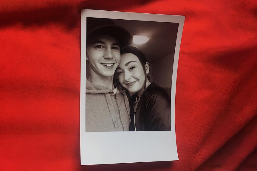 Polaroid of two young people smiling and cuddling