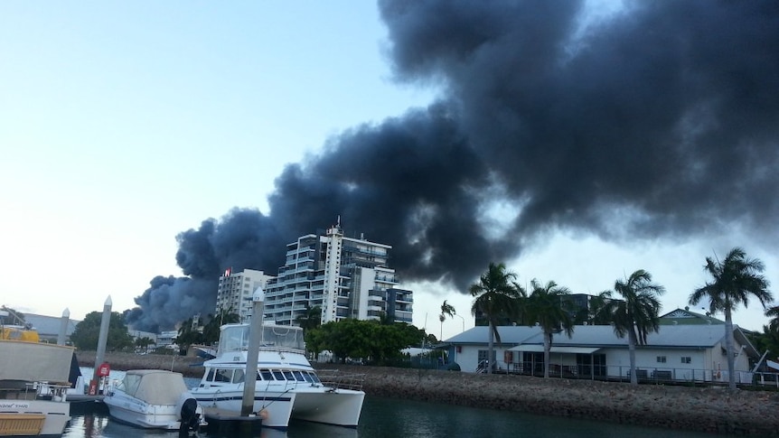 Thick black smoke plumes from a scrap metal and plastic rubbish fire at Port of Townsville
