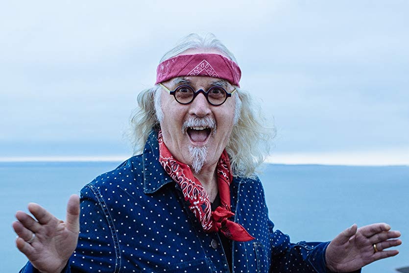 Billy Connolly smiling at the camera.