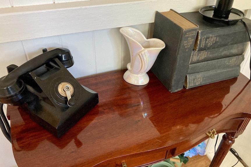 An old 1940s style phone on a table.