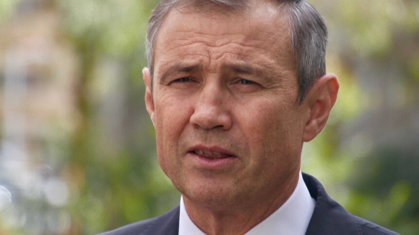 A head shot of Roger Cook, background out of focus.