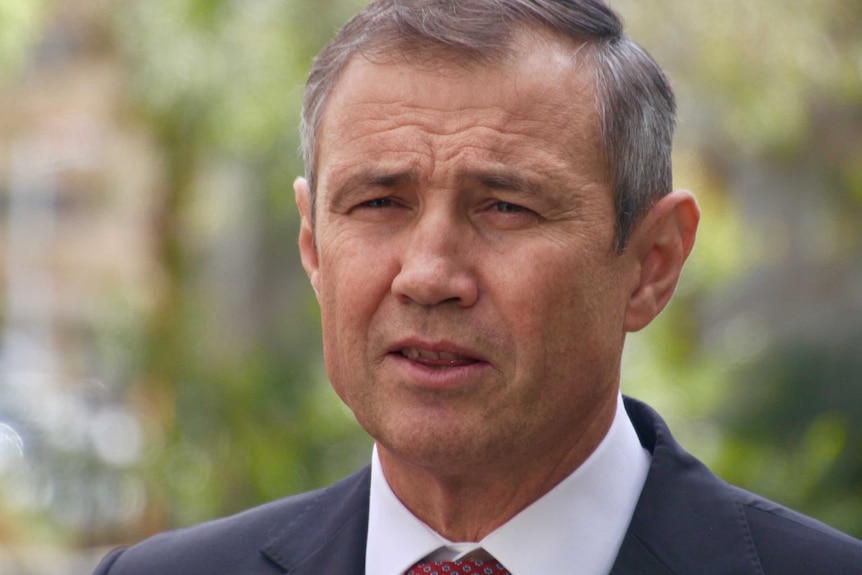 A head shot of Roger Cook, background out of focus.