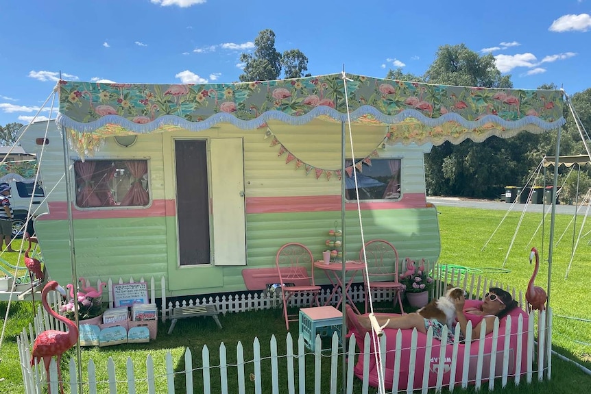image of an old caravan painted pale pink and green