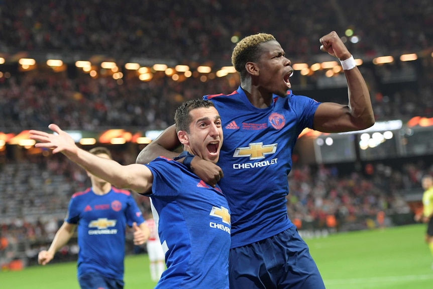 Henrikh Mkhitaryan (L) of Manchester United celebrates a goal with teammate Paul Pogba
