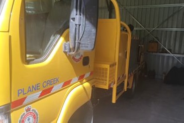 The side of a fire truck with the words "Plane Creek" visible on it