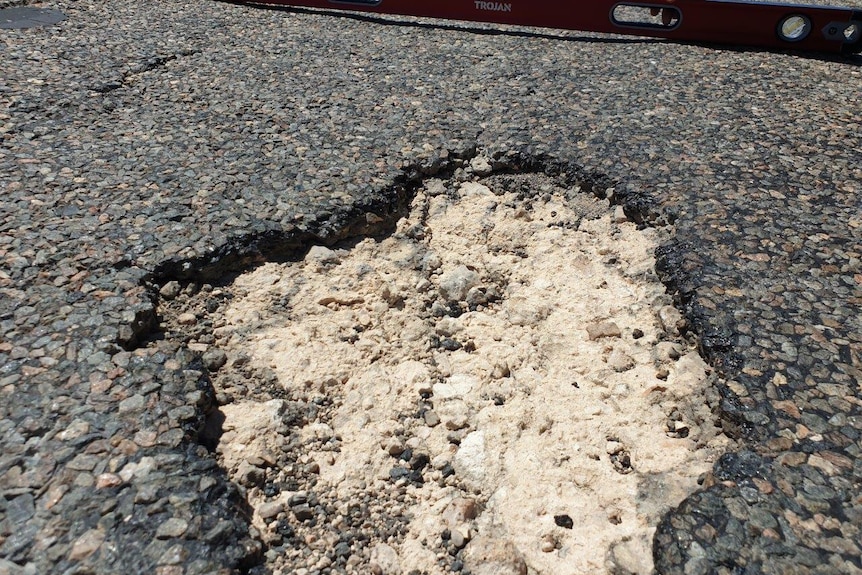 A photo of a pothole on a main road. 