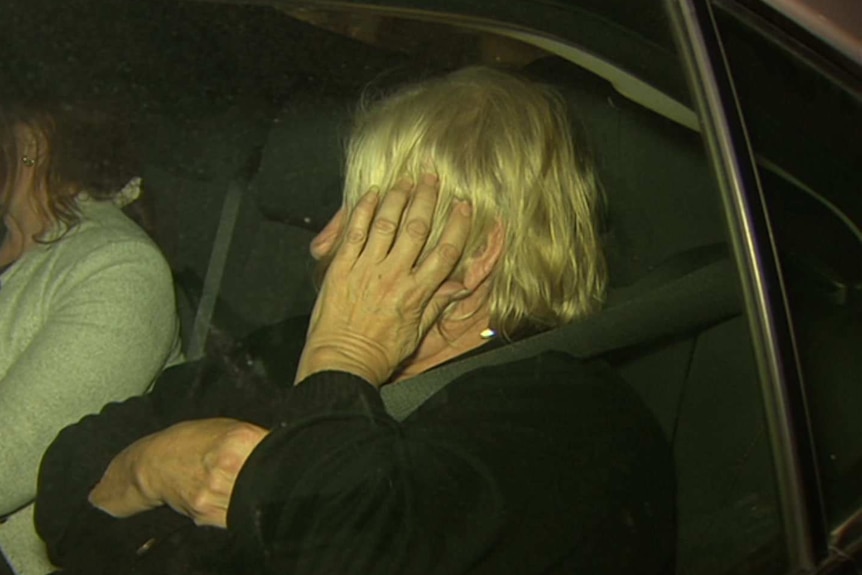 Disability care worker Rosemary Maione exits a car after her arrest.