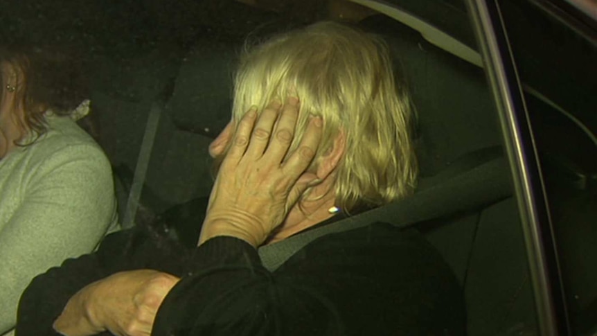 Disability care worker Rosemary Maione exits a car after her arrest.