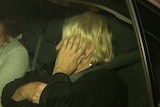 Disability care worker Rosemary Maione exits a car after her arrest.