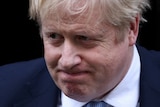British Prime Minister Boris Johnson grimaces as he leaves Downing Street.