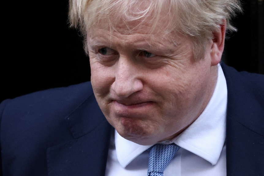 British Prime Minister Boris Johnson grimaces as he leaves Downing Street.