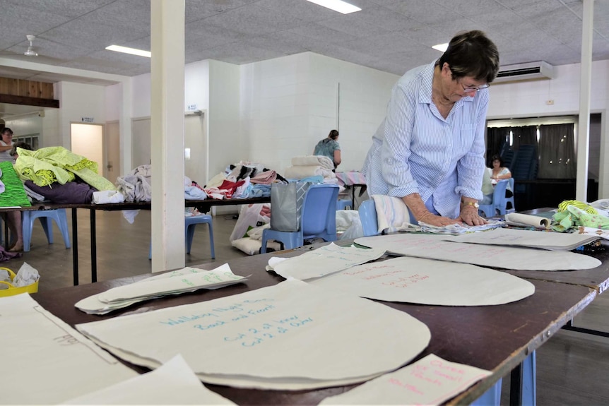 Long tables covered with sewing patterns.