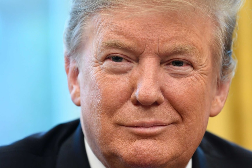 A close up of Donald Trump's face