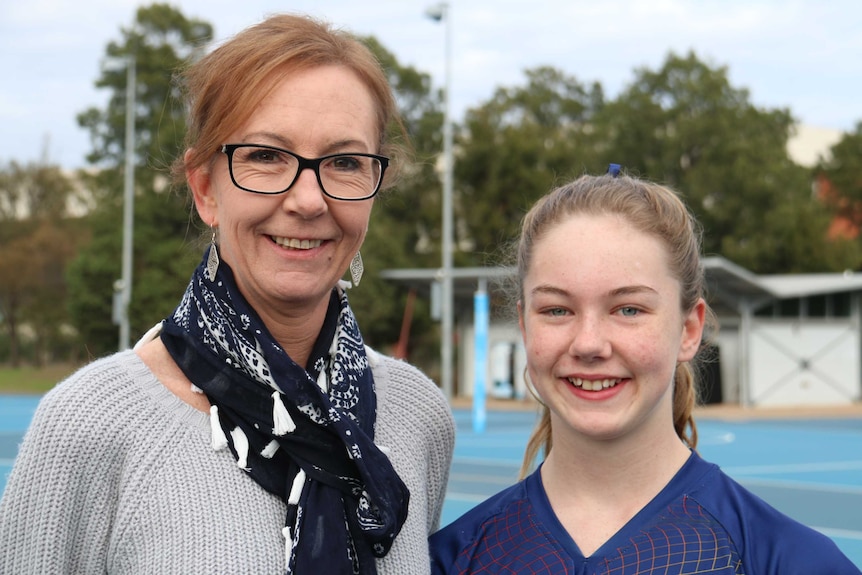Olivia pictured with her mum after playing a game of netball.