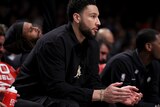 Ben Simmons sits and claps his hands