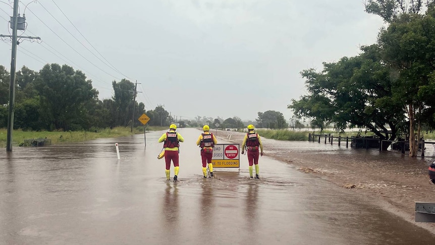 Queensland fire and rescue wade through flooded streets