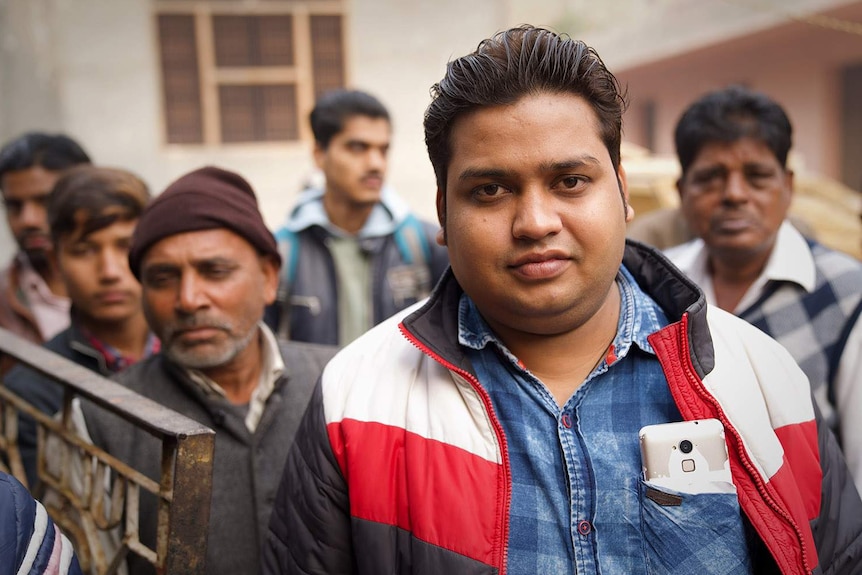 Elephant owner Mahboob Ali, standing in a group of men in New Delhi.