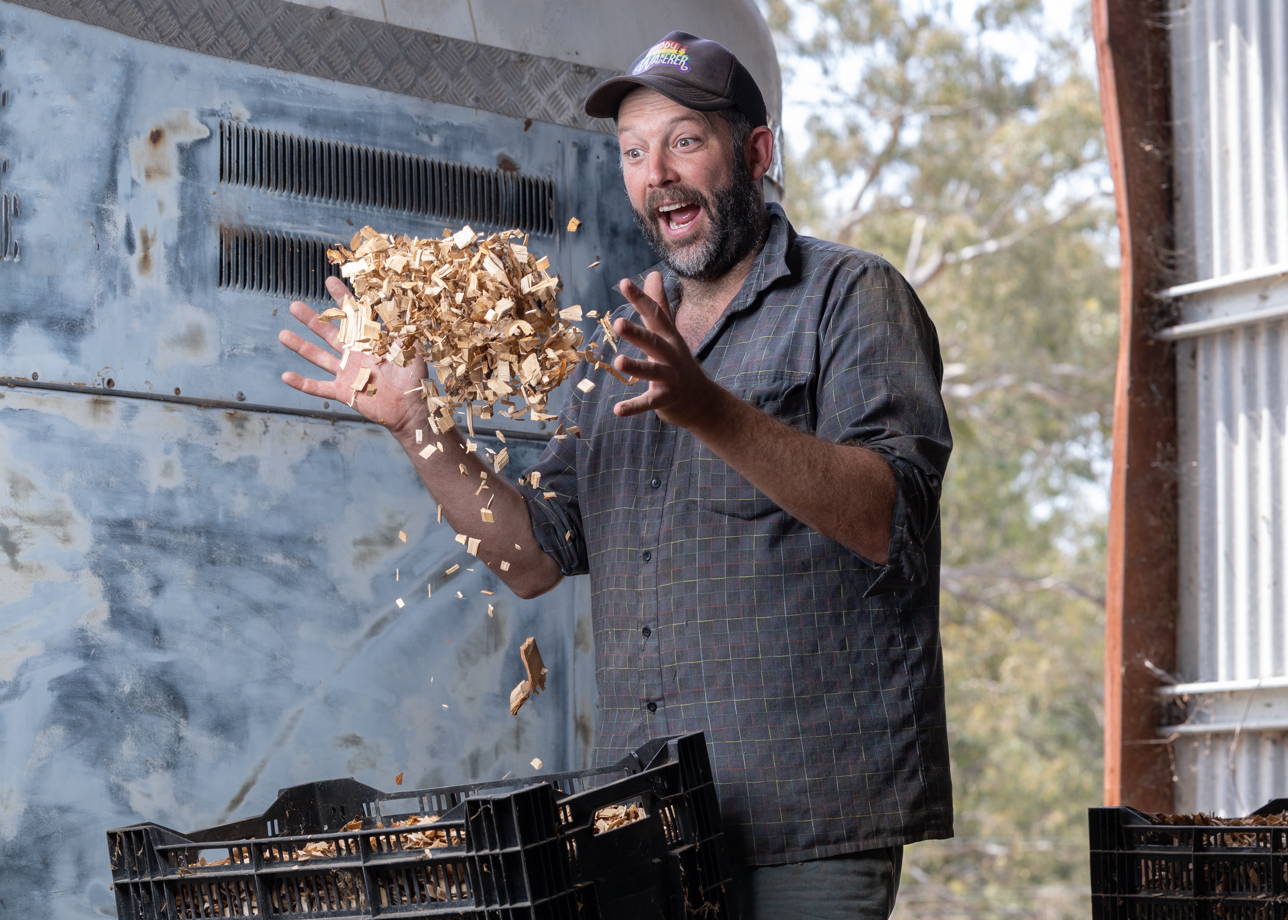 A man throw a pile of wood timbers in the air