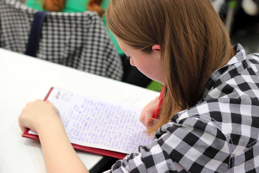 A lady writing on a piece of paper