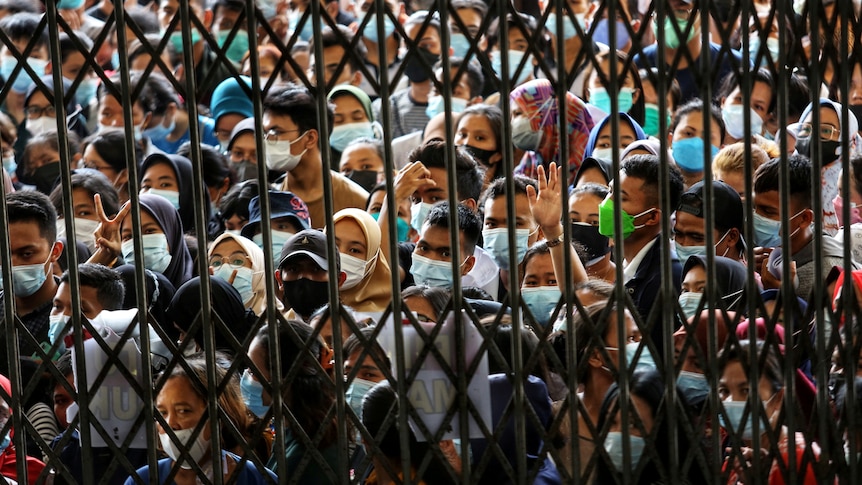 Crowds throng a vaccination centre in North Sumatra province on August 3, 2021.