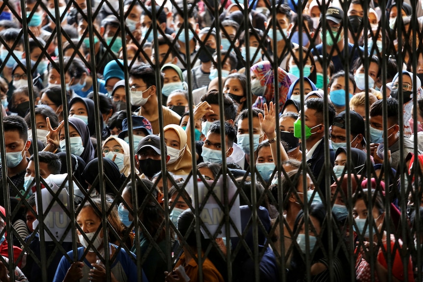 Crowds throng a vaccination centre in North Sumatra province on August 3, 2021.