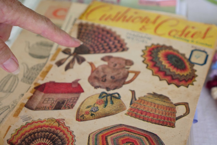 The front of an old tea cosy pattern book, showing images of knitted tea cosies.