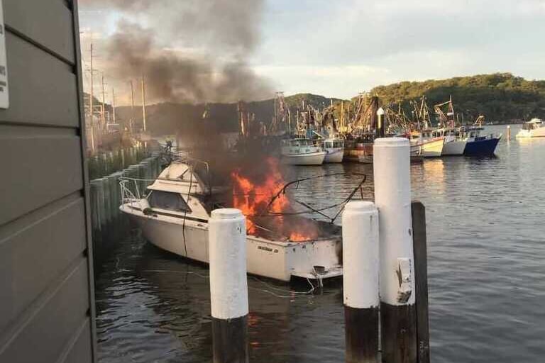a boat on the water burning