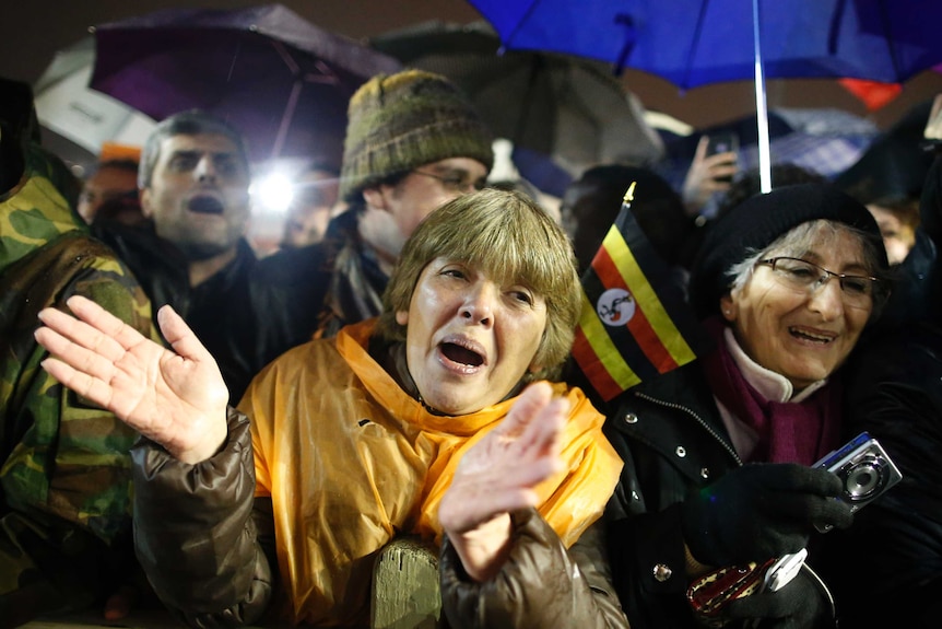 Woman claps upon election of pontiff