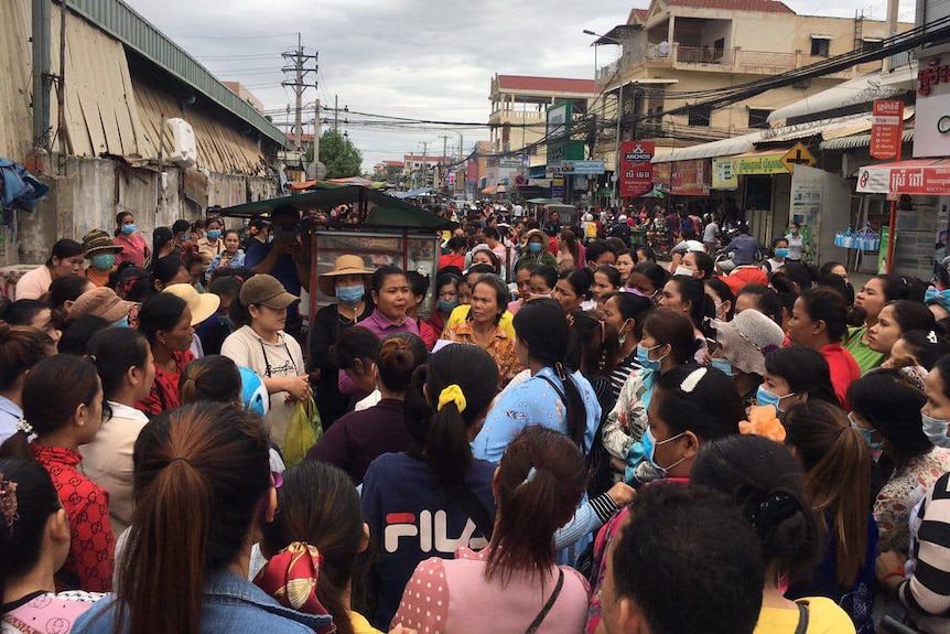 Cambodian women crowd on a street in Phnom Penh.