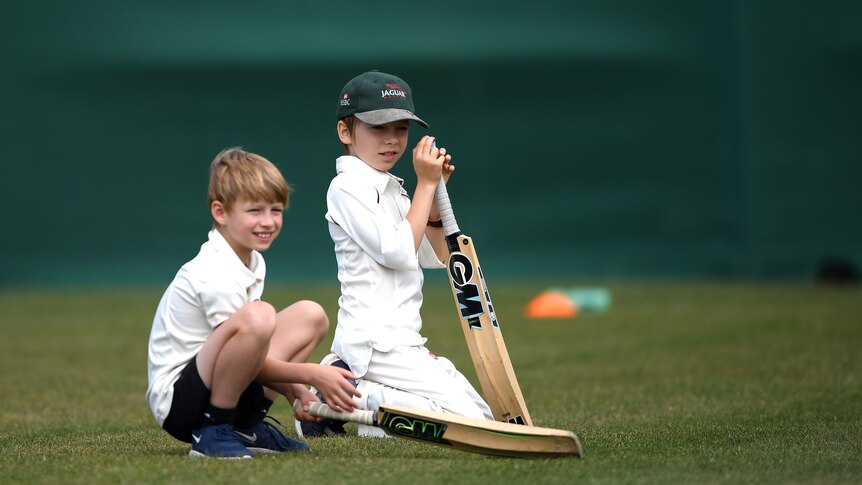 Two children prepare to start cricket training