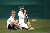 Two children prepare to start cricket training