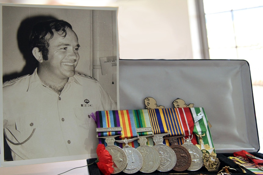 A photo of Bob Wood in his service days alongside his service medals
