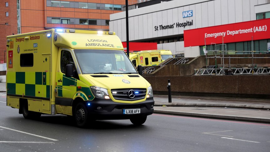 An ambulance drives past St Thomas' Hospital in London
