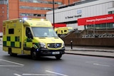 An ambulance drives past St Thomas' Hospital in London