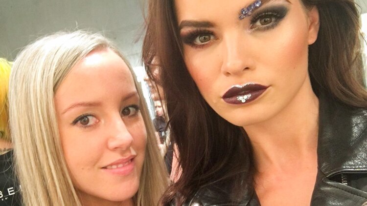 Nicole Bratis stands next to a model who she created make-up for during Fashion Week Australia.