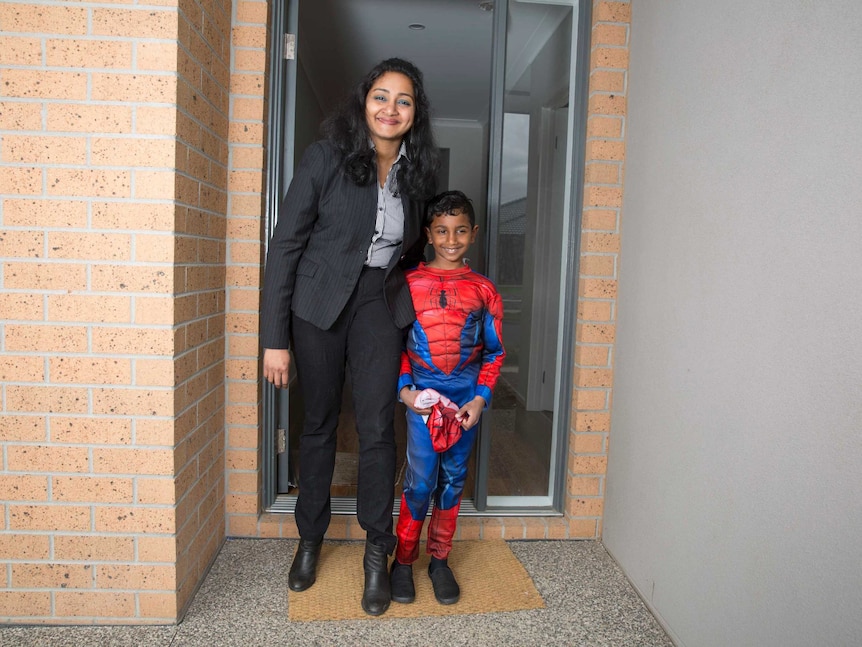 Single mother Paurnami Jitesh and her son Dev out the front of their home.