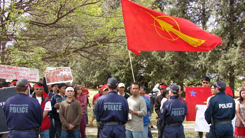 Police confront protesters outside the Burmese Embassy.