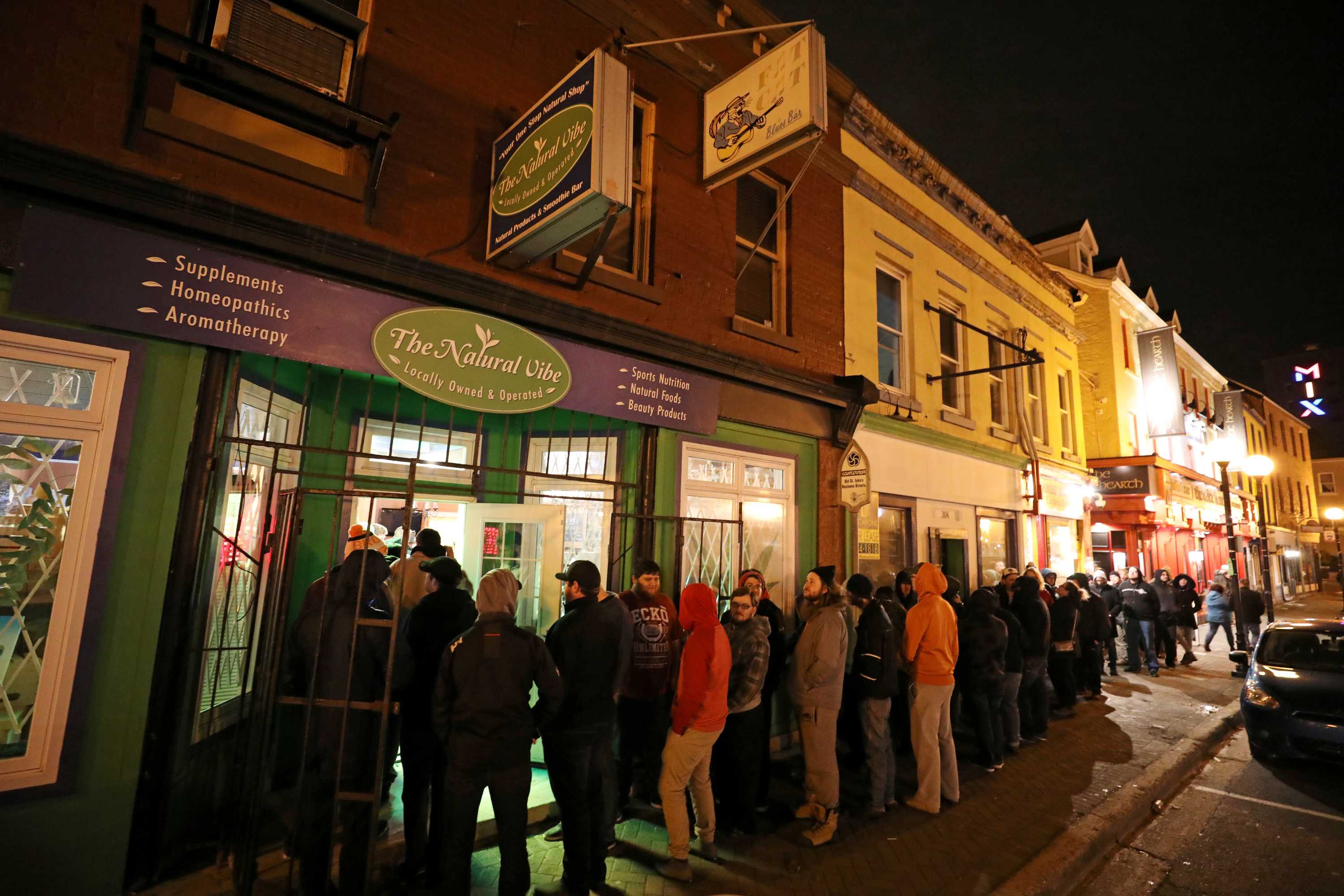 Customers line up outside the Natural Vibe store after legal recreational marijuana went on sale in Canada.