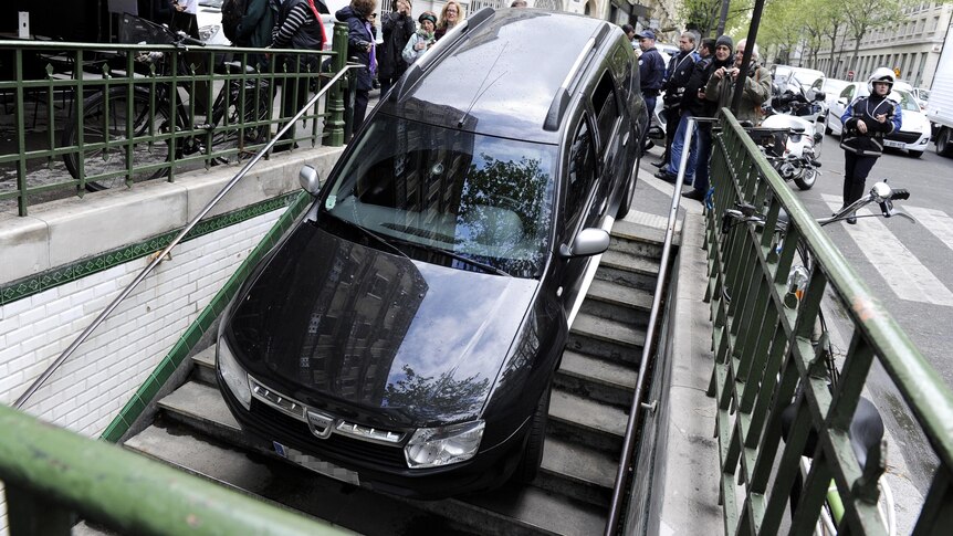 A car takes a wrong turn into Chaussee-d'Antin La Fayette subway station in Paris.