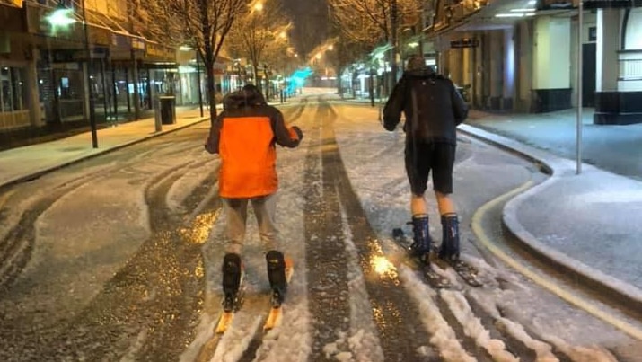Two people ski through snow on Launceston street.