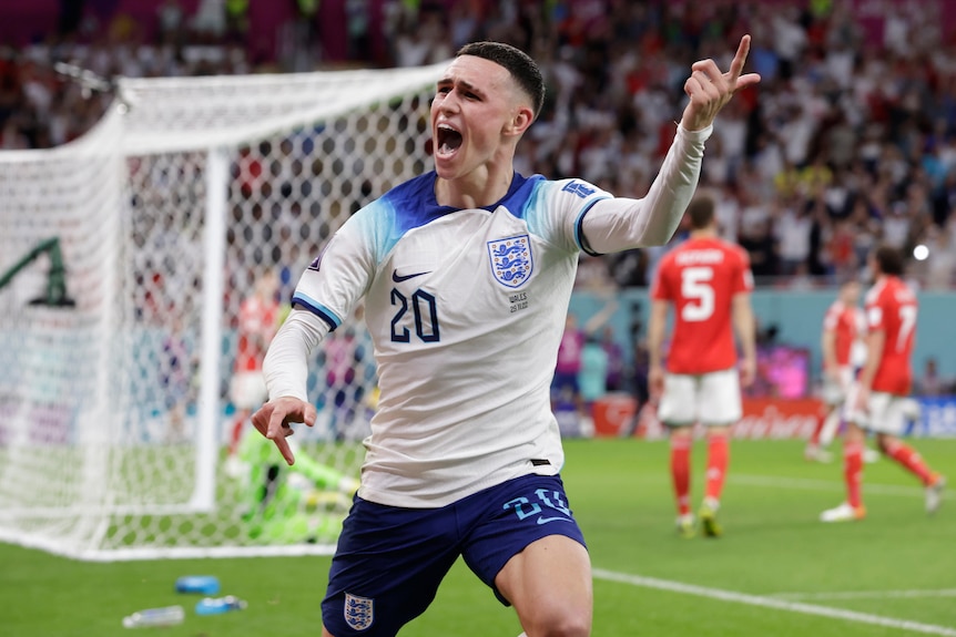 Phil Foden waves his finger up in the air and screams in joy